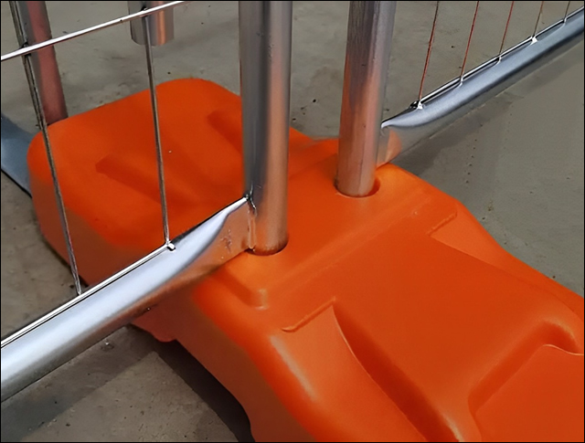 Orange plastic feet for temp fence support and fixing